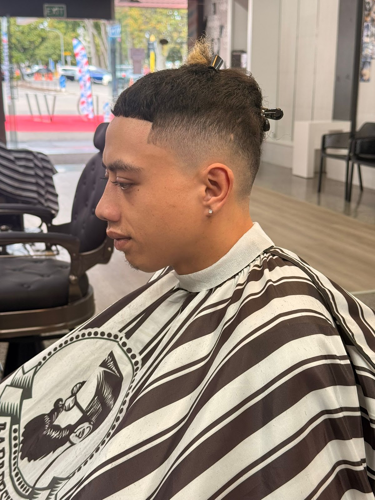 Top knot with clean skin fade at Prime Barbers
